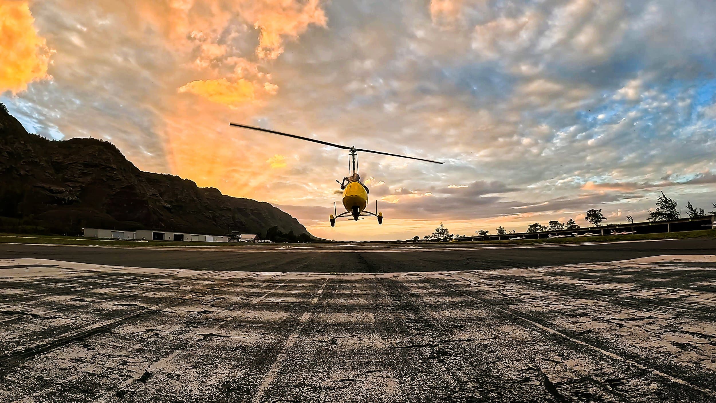 Skyland Air gyroplane silhouetted against a North Shore sunset.